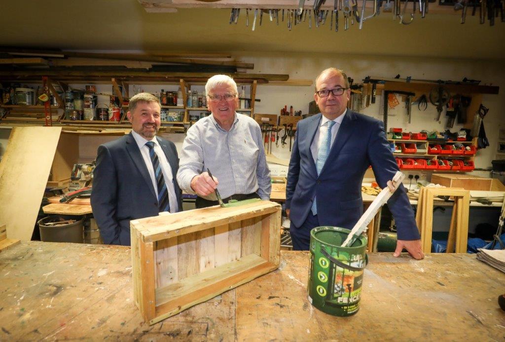 Health Minister Robin Swann, CMO Professor Michael McBride and (centre) Joe McCusker chairman of the North Belfast Men's shed