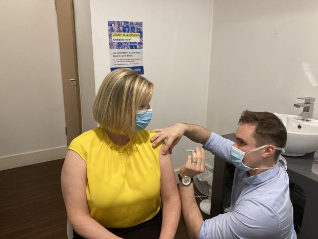 Chief Pharmaceutical Officer Cathy Harrison pictured receiving her winter vaccines at Woodbourne Pharmacy in Belfast.