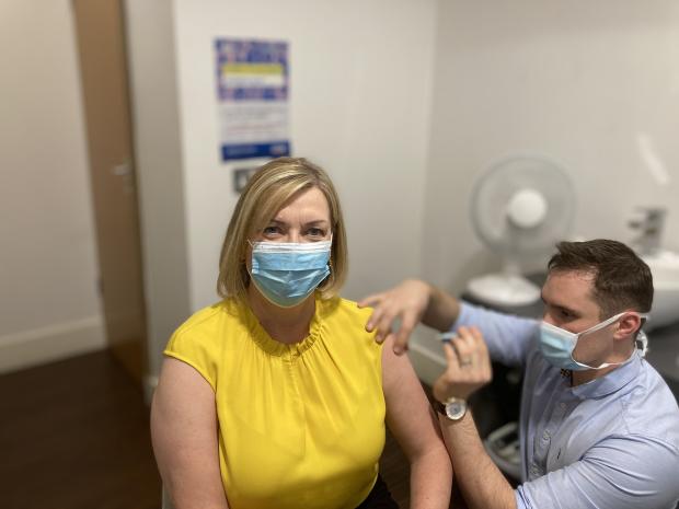 Chief Pharmaceutical Officer Cathy Harrison pictured receiving her winter vaccines at Woodbourne Pharmacy in Belfast.