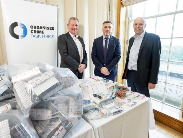 Pictured with drug seizures (l to r) are Richard Pengelly, Permanent Secretary, Department of Justice; Andy Hill, Detective Chief Superintendent, Police Service of Northern Ireland and Peter May, Permanent Secretary, Department of Health.