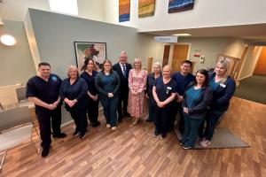 Photo of Mike Nesbitt with GP practice staff