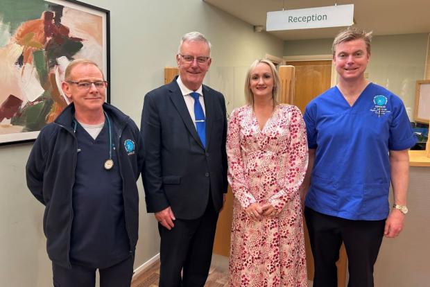 Photo of Mike Nesbitt with staff at GP Practice