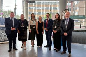 Photo of stroke survivor Gemma O’Hara with Health Minister Robbie Butler with health officials